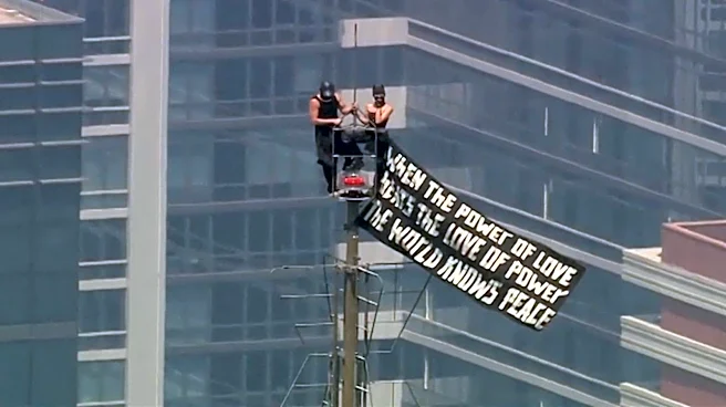 Russian daredevils unfurl banner atop New York's Empire State Building in proposal stunt