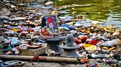 Yamuna water level drop reveals religious waste at Delhi ghats