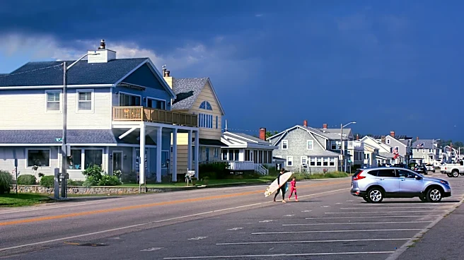 Rainy Weekend at Hampton Beach: Tourists Adapt with Umbrellas