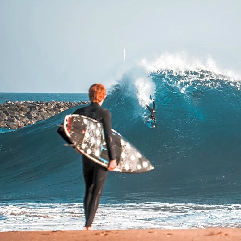Spectators Flock to Newport Beach's Wedge Amid High Surf Conditions