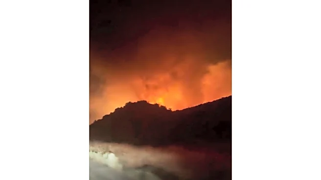 Firefighters make progress against fast-moving blaze along highway north of Los Angeles