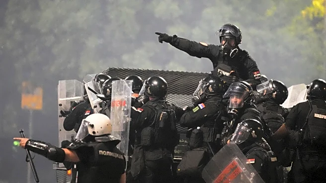 Tensions soar in Serbia as angry protesters clash with police, set fire to party offices