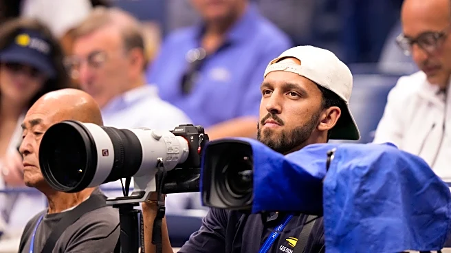 Basketball player Landry Shamet takes his shots as a photographer working at the US Open