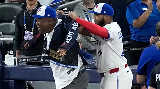Joe Carter wears Blue Jays' home run jacket after throwing first pitch at World Series Game 2