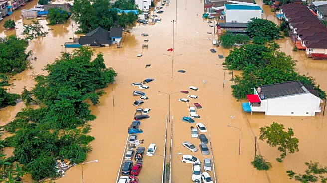 Families in southern Thailand perch on rooftops to escape flooding that has killed at least 33