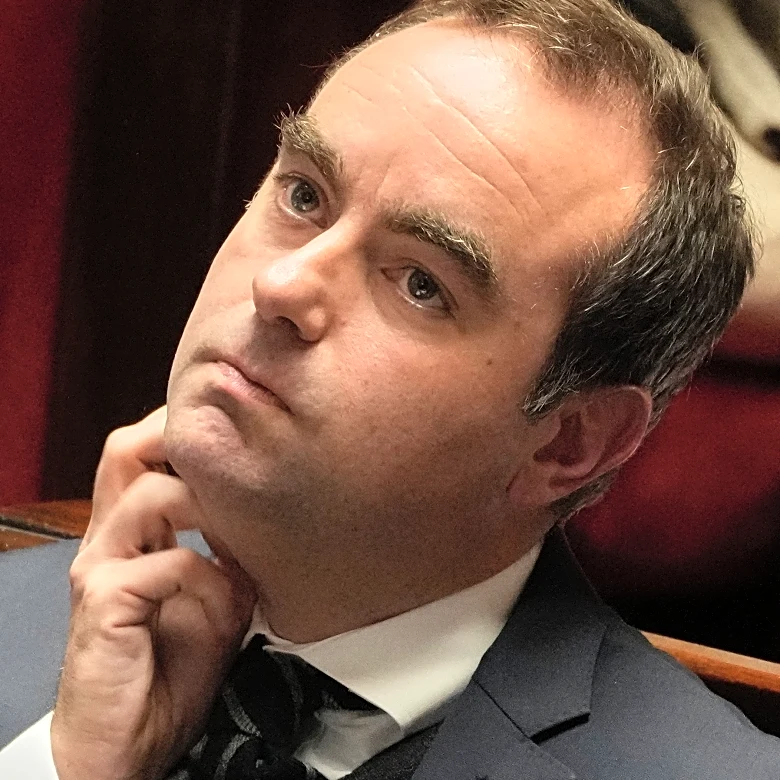 French lawmakers narrowly approve health care budget, suspending Macron's flagship pension reform