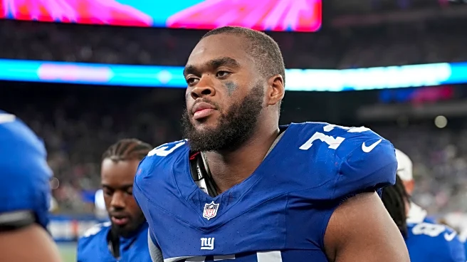 Evan Neal practices with the Giants. He's still not sure he'll play for them again