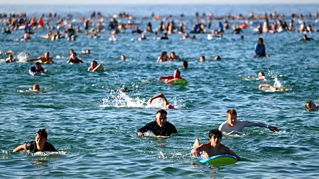 A sunrise crowd gathers at Bondi Beach in solace and defiance after a massacre