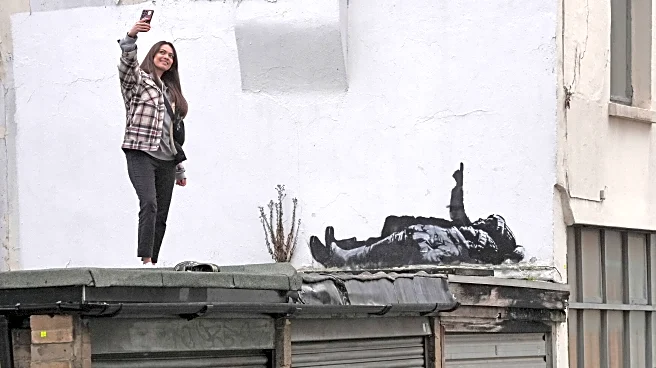 Banksy unveils new art in London following speculation over murals depicting stargazing figures