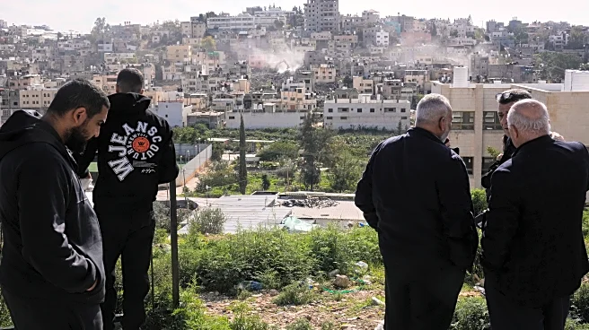 Palestinians watch as Israeli bulldozers claw down their West Bank homes