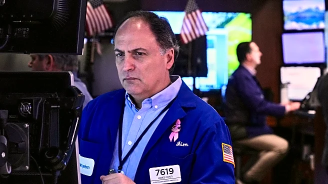 Stocks edge a bit below their latest records on Wall Street