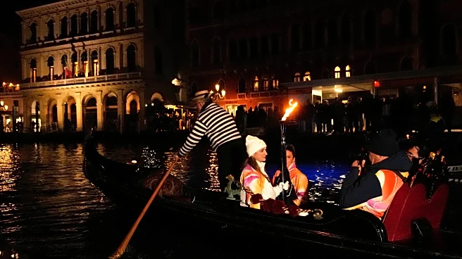Olympic flame glides on traditional Venetian boats down the Grand Canal