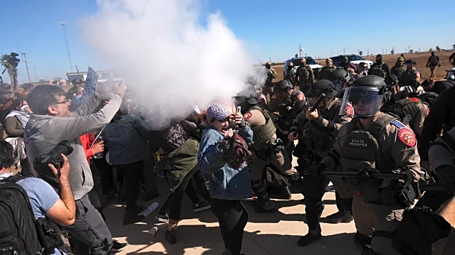 Officers confront protesters at Texas facility as lawmaker visits father, son detained in Minnesota