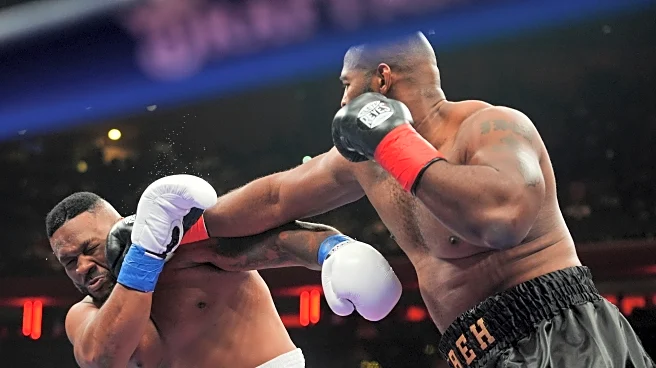 Boxer Jarrell Miller has his hairpiece knocked upward by a punch, then throws it into the crowd