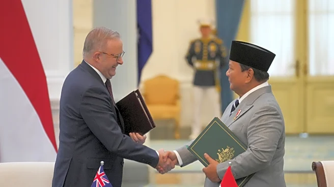 Leaders of Indonesia and Australia sign a new security treaty to affirm deeper ties
