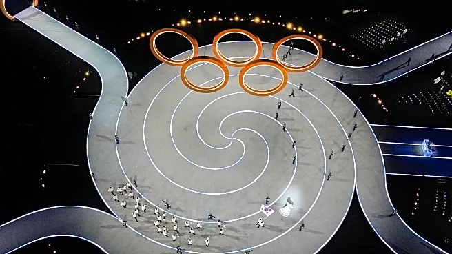 Olympians march in Milan and the mountains at a multi-site opening ceremony for the Winter Games