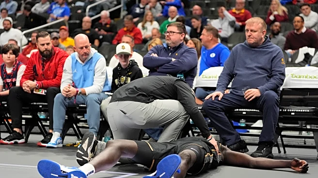 UCF's John Bol helped off court after collapsing and clutching his chest in Big 12 game
