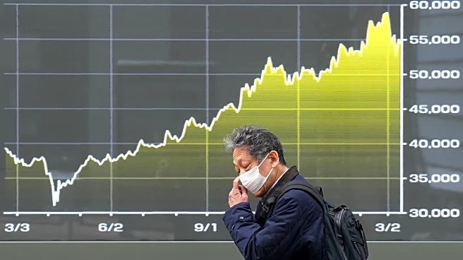 Asia shares are mostly lower and oil hovers near $100 a barrel over Iran war worries