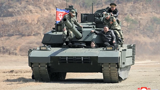 Teen daughter of North Korean leader Kim drives a tank while observing drill with her father