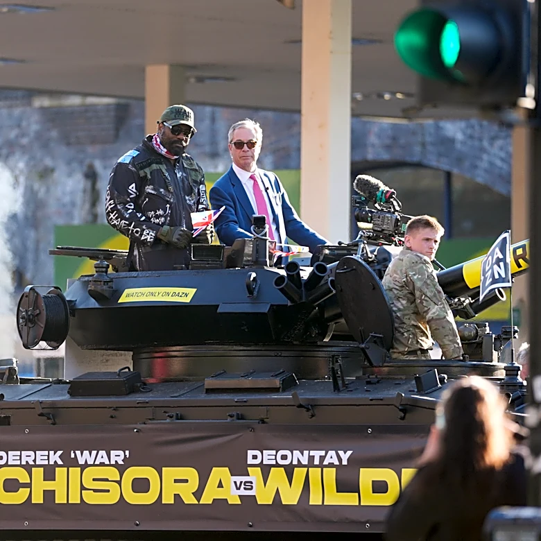 Heavyweight boxer Derek Chisora rides army tank with Nigel Farage to press event