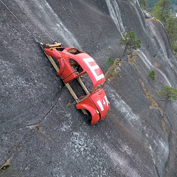 Car shell suspended on rock face above British Columbia highway in apparent prank