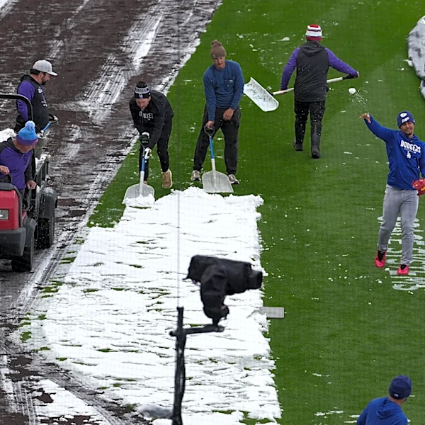 A mid-April snowstorm coats Coors Field as Dodgers-Rockies series gets off to frosty start