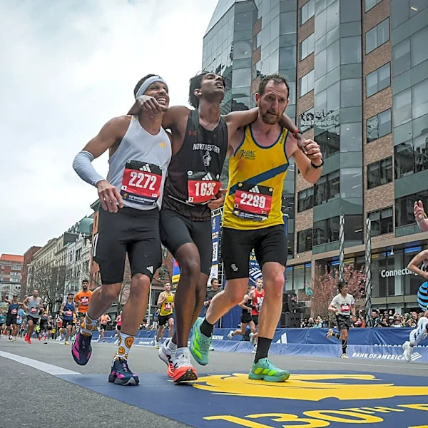 Runners were struggling to finish Boston Marathon when competitors came along and helped them across