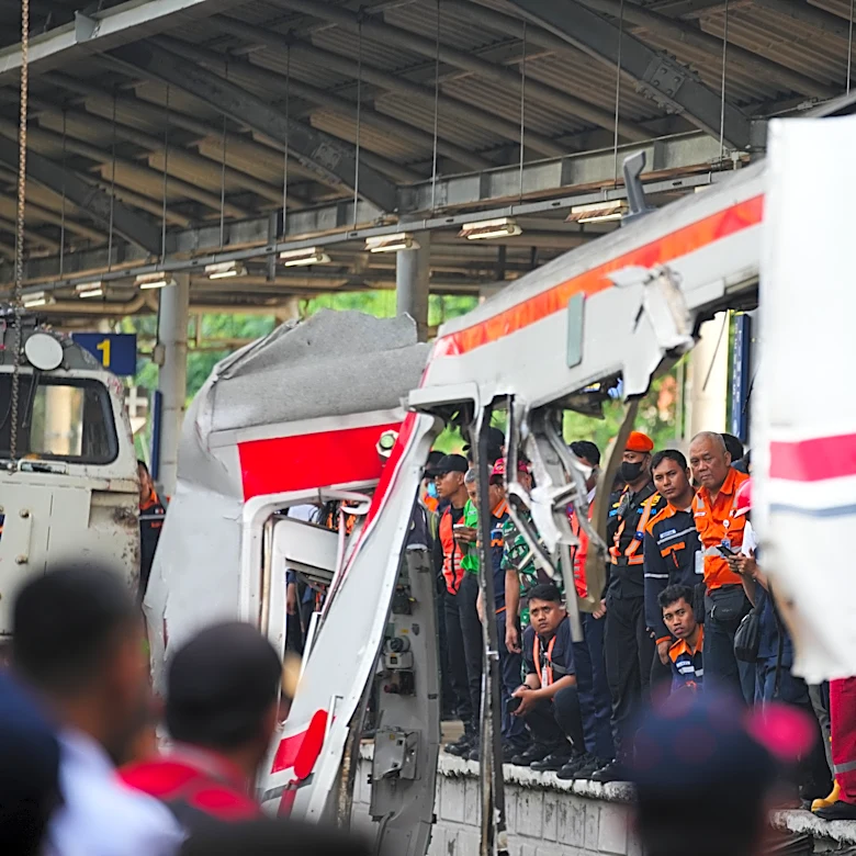 Rescuers trying to reach 3 people trapped in damaged train car after crash in Indonesia
