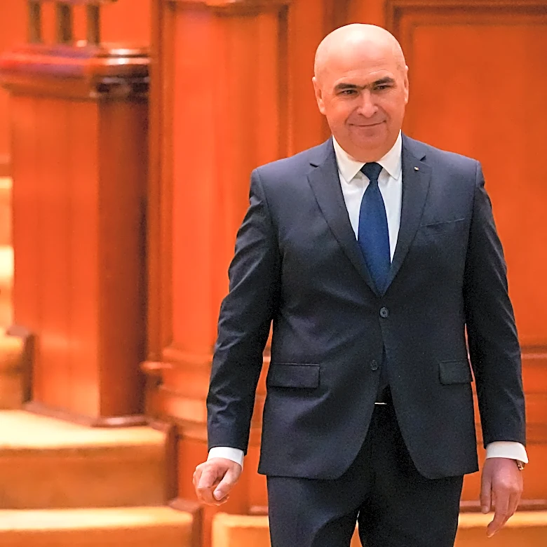 Romania's prime minister fights for survival as no-confidence motion is debated in Parliament
