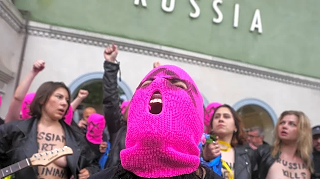 Protesters in pink balaclavas swarm Russia's pavilion at Venice Biennale and release colored smoke