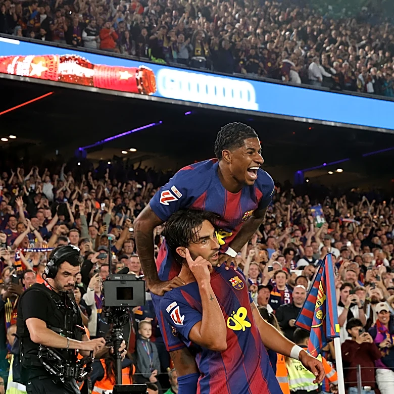 Watched by its grieving coach, Barcelona retains Spanish league title after beating Real Madrid 2-0