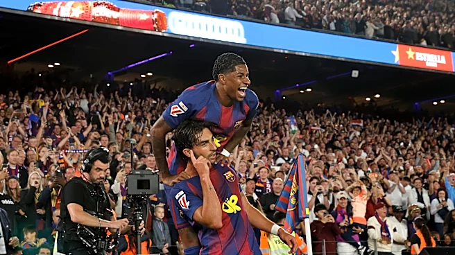 Watched by its grieving coach, Barcelona retains Spanish league title after beating Real Madrid 2-0