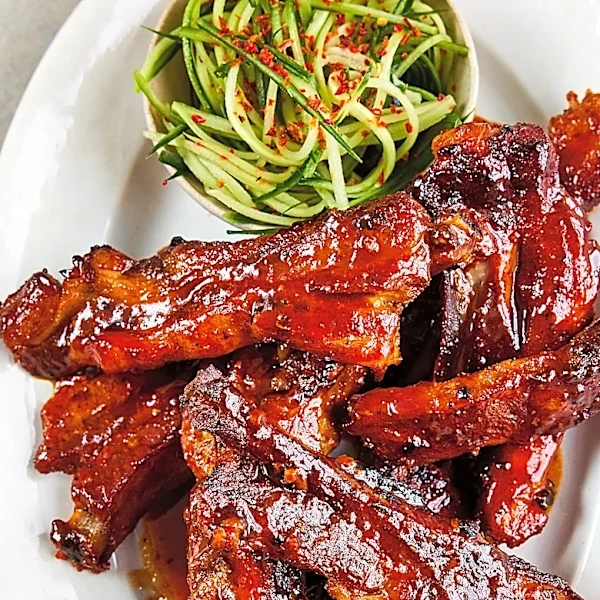 Slow-cooked, sticky-glazed pork ribs go with cucumber slaw in Sam Way's recipe