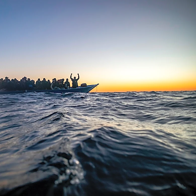 Aid group says Libyan-linked vessels fired on a migrant rescue ship in the Mediterranean