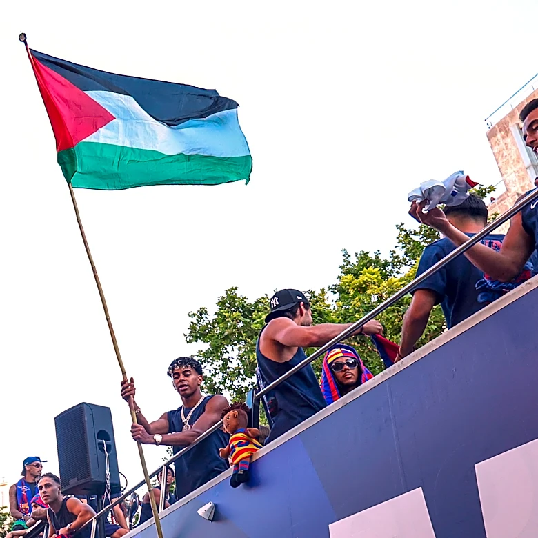 Barcelona star Lamine Yamal waves Palestinian flag during title parade
