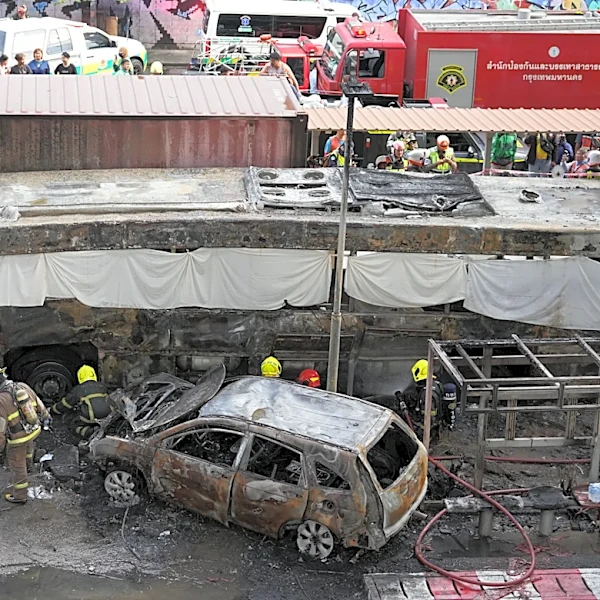 A cargo train hits a public bus at a Bangkok rail crossing, killing at least 8