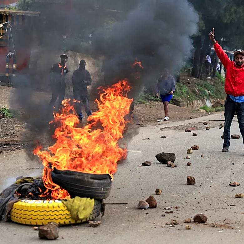 Protesters light bonfires during public transport strike in Kenya over fuel prices