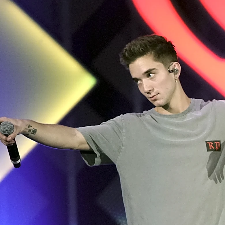 Ex-girlfriend of boy band member charged with trying to hire a hitman to kill him