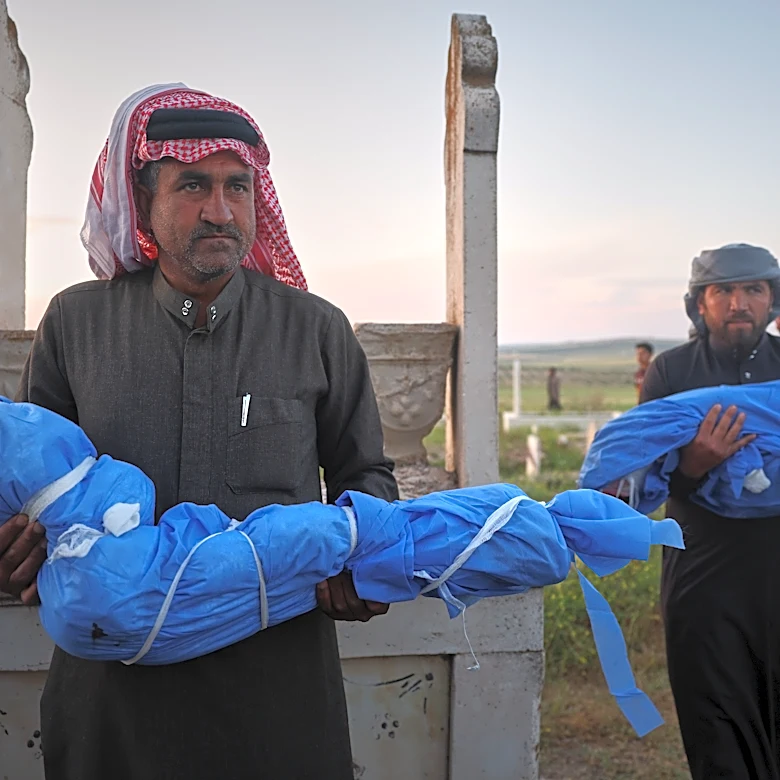 A grieving father buries his 6-year-old after a land mine kills 3 children in Syria's Idlib