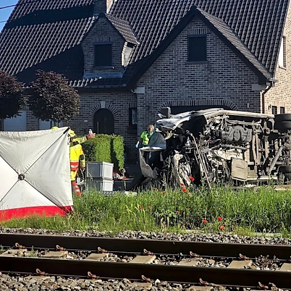 Several hurt in a crash between a train and a minibus, Belgian police say