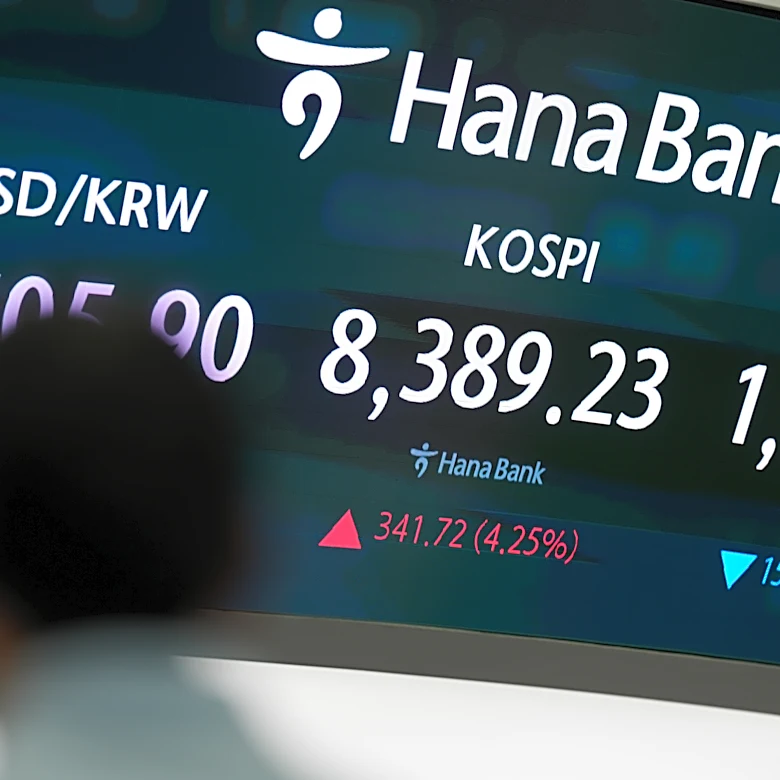 Asian shares are mostly higher, tracking Wall Street's fresh records, and oil prices fall