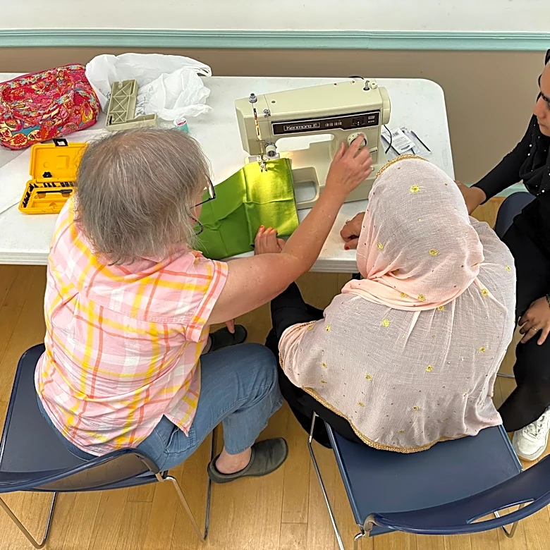 After refugee aid cuts, faith groups help Afghan women connect through sewing