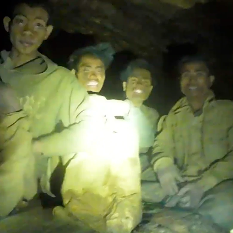 Rescuers evacuate the first of 5 villagers found trapped in a cave in Laos; 2 still missing