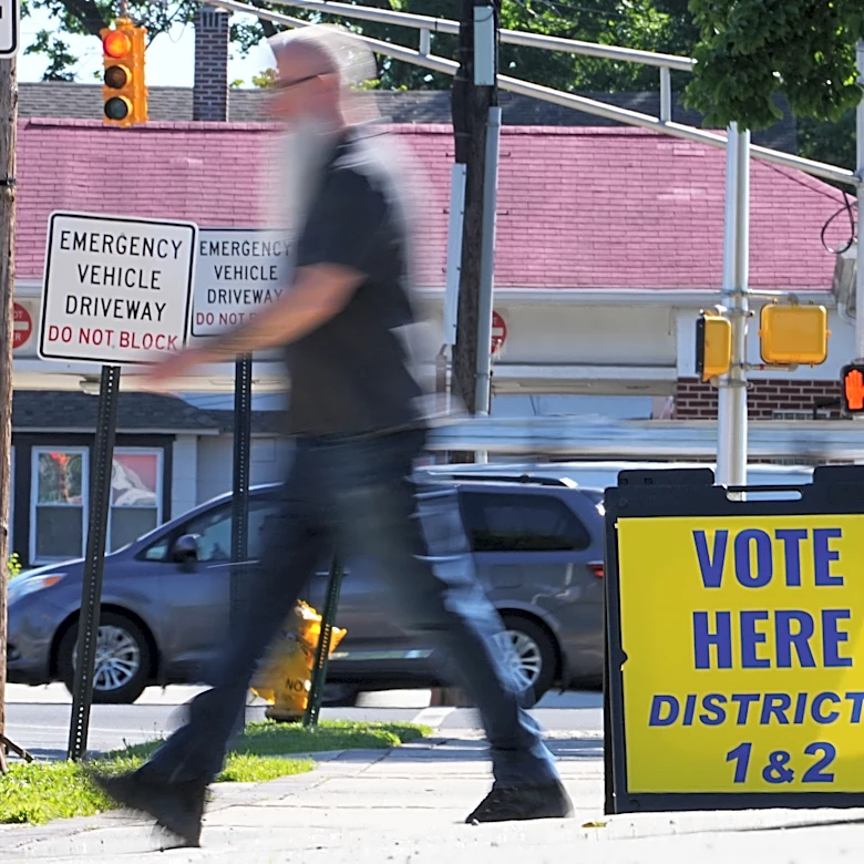 The Latest: Polls open for races across the US as a busy primary election day gets underway