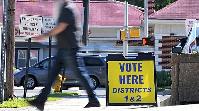The Latest: Polls open for races across the US as a busy primary election day gets underway