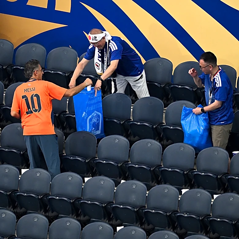 Japan fans use blue bags to uphold a cleansing World Cup tradition after draw
