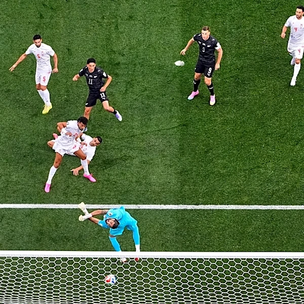 One Extraordinary Photo: An overhead look at New Zealand’s Elijah Just scoring against Iran