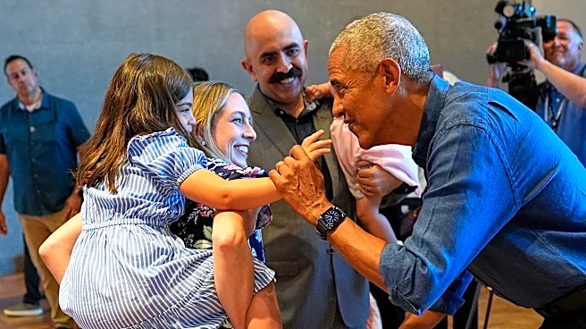 Barack and Michelle Obama surprise first visitors to newly opened presidential center