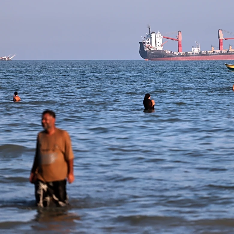 British military says a cargo ship was hit while moving through the Strait of Hormuz