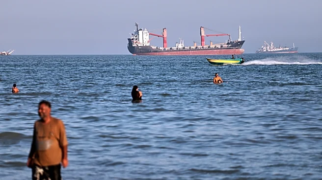 British military says a cargo ship was hit while moving through the Strait of Hormuz